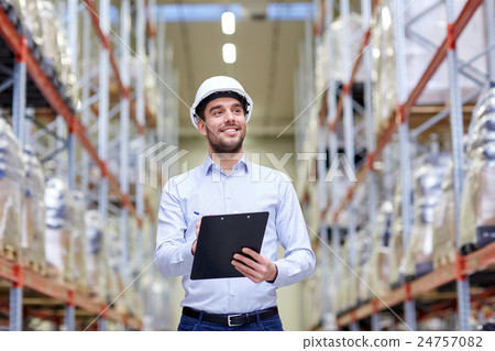 happy businessman with clipboard at warehouse 24757082