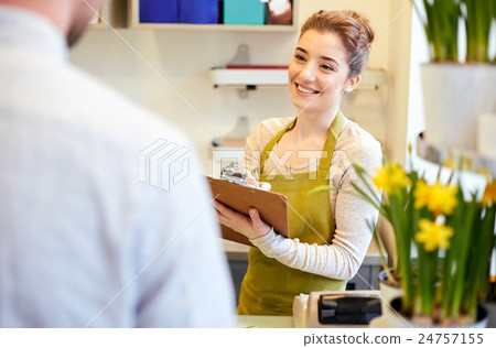 florist woman and man making order at flower shop 24757155