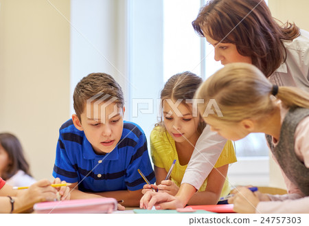 group of school kids writing test in classroom group of school kids writing test in classroom 24757303