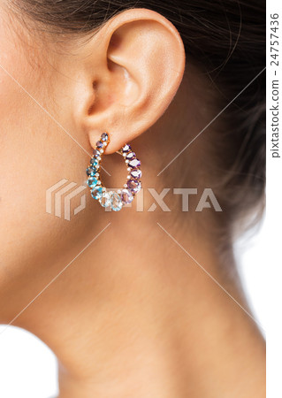 close up of beautiful woman face with earring 24757436