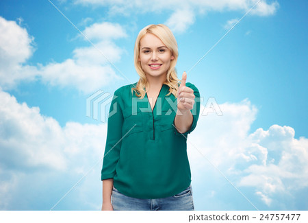 smiling young woman in shirt showing thumbs up smiling young woman in shirt showing thumbs up 24757477
