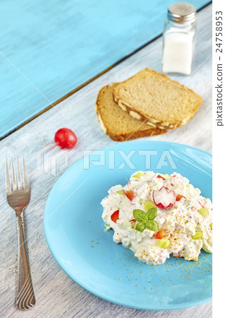 Cottage cheese with radish on blue plate. Cottage cheese with radish on blue plate. 24758953