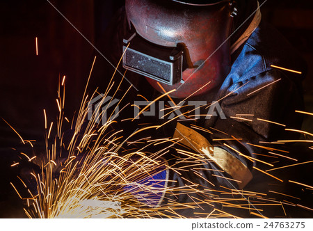 Welder is welding in car factory 24763275