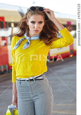 Pretty young woman at a train station Pretty young woman at a train station 24763528