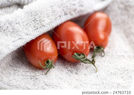 Red virgin tomato in a towel 24763710