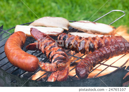Sausages and bacon on the grill 24765107