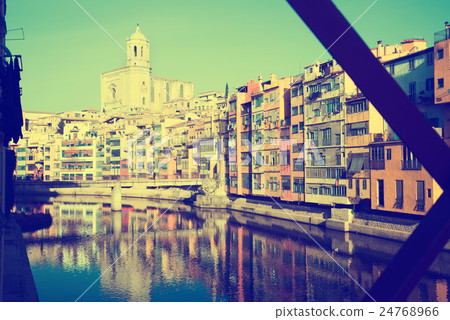 picturesque houses and church from Eiffel bridge in Gerona. Catalonia 24768966