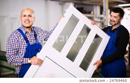 Workmen inspecting PVC manufacturing output 24769468