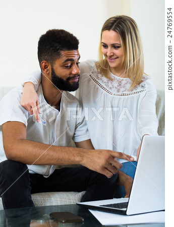 young interracial couple near laptop 24769554