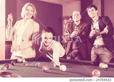 Group of friends playing billiards 24769682