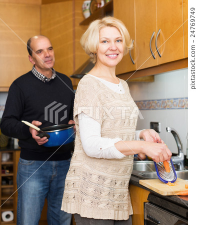 Husband helping wife to cook 24769749