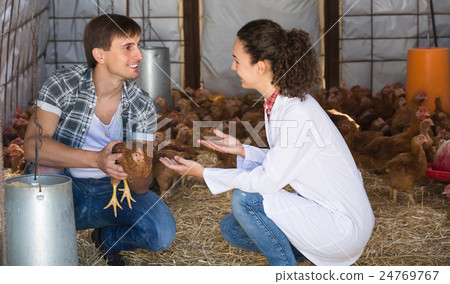 Woman veterinarian chatting with farm worker Woman veterinarian chatting with farm worker 24769767