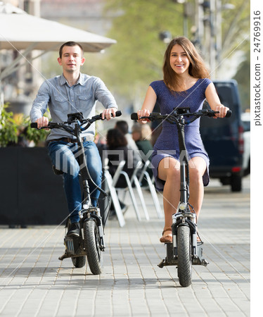 Young couple with electric bikes . 24769916