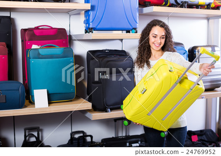 Woman selecting handy trunk in store. 24769952