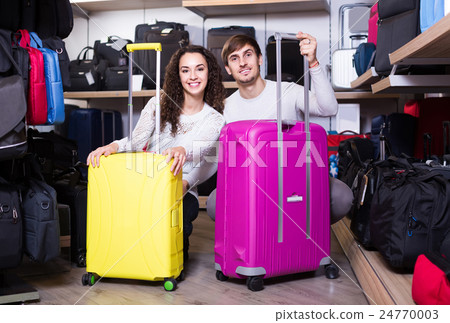 customers looking at roll-aboard bags in store 24770003