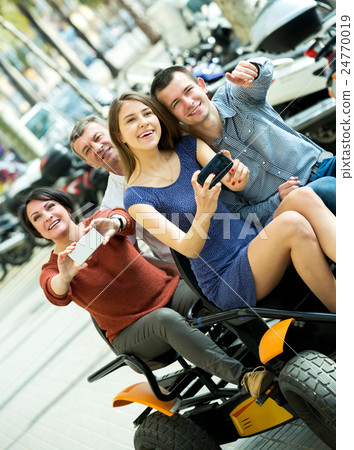 Family of four sitting in grand tour electric Family of four sitting in grand tour electric 24770019