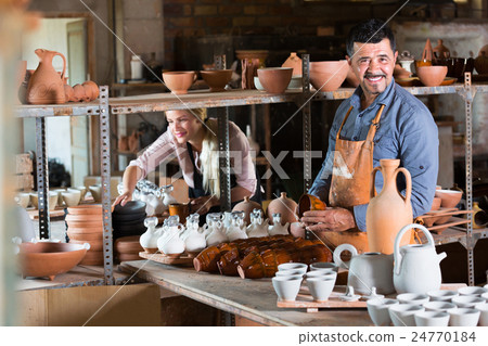 Two glad craftsmen with ceramic 24770184