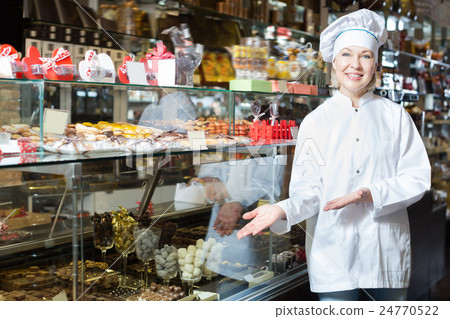 Happy woman selling chocolates 24770522
