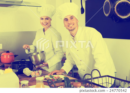 Two chefs cooking food 24770542