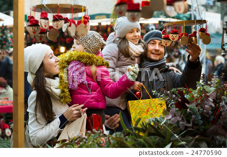 Family with children purchasing toys Family with children purchasing toys 24770590