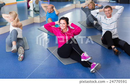 people training in a gym on sport mats 24770591