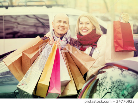 Portrait of smiling pleasant mature couple standing 24770922