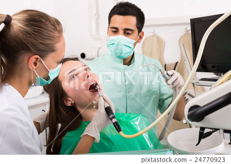 patient checking out her teeth at dentist patient checking out her teeth at dentist 24770923