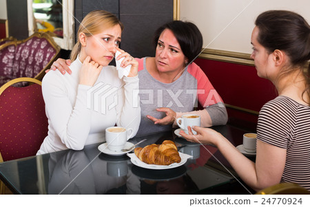 Portrait of three hectic woman sitting in the cafe 24770924