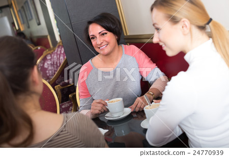 Female friends in the cafeteria. 24770939