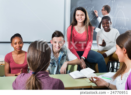 Girls and boys relaxing together between the classes 24770951