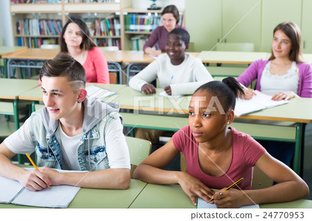 Pupils at the lesson in the school. Pupils at the lesson in the school. 24770953