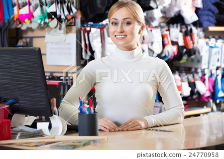 Smiling blond girl cashier at the pay desk 24770958