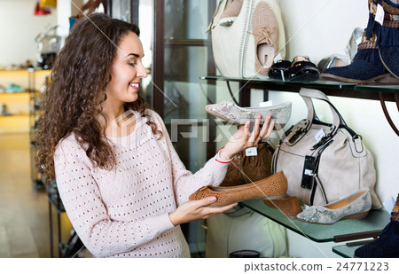 Young smiling beautiful woman shopping at store Young smiling beautiful woman shopping at store 24771223