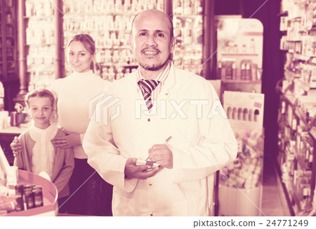 pharmacist helping customers pharmacist helping customers 24771249