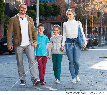 Family taking a walk in town 24771274