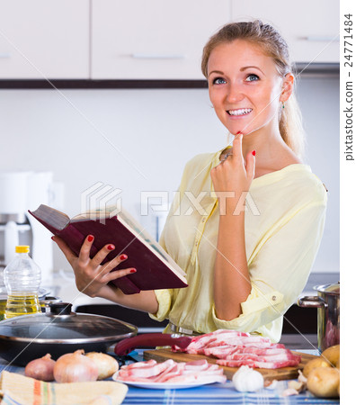 Housewife cooking with meat. 24771484