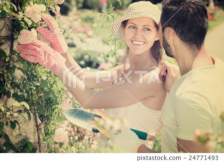Girl in flowers garden with her boyfriend 24771493