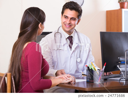 Patient and therapeutist at desk in clinic. Patient and therapeutist at desk in clinic. 24771686