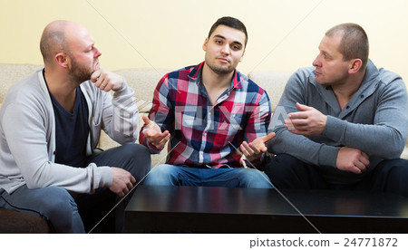 Friends with upset faces discussing 24771872