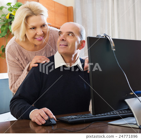 Senior couple talking with someone 24771896