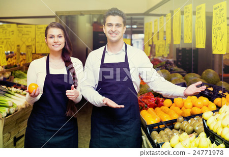 Positive smiling sellers offering good price for fruits 24771978