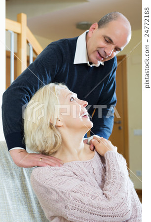 Husband massaging neck to wife 24772188