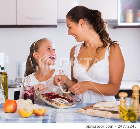 Woman and child cooking strudel 24772245