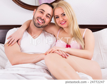 Couple posing in bed 24772247