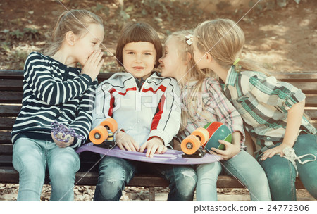 Kids sharing secrets as talking outdoor. Kids sharing secrets as talking outdoor. 24772306