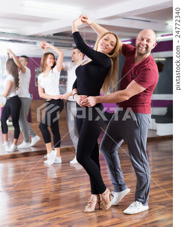 Couples enjoying of partner dance 24772340