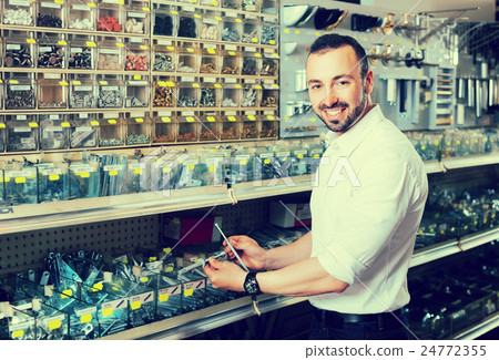 Man picking plastic dowel 24772355