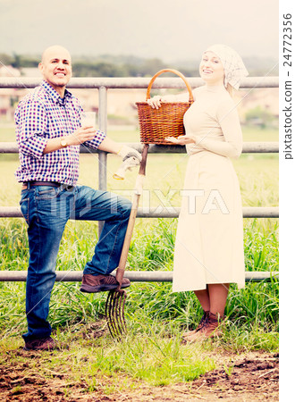 Two adult farm workers taking a pause Two adult farm workers taking a pause 24772356