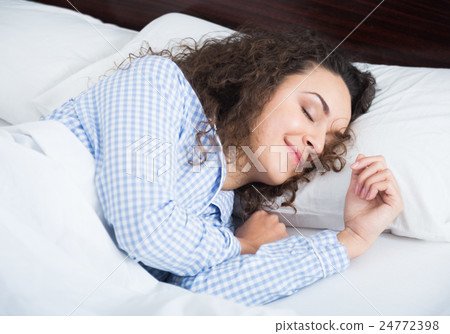 Cute adult girl smiling in her sleep 24772398