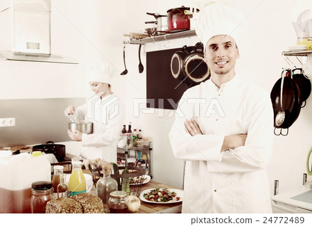 male chef at cafe's kitchen. male chef at cafe's kitchen. 24772489